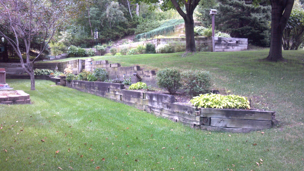 Backyard renovation landscaping with brick retaining wall