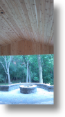 Inside Cedar Arbor and fire pit with seat wall